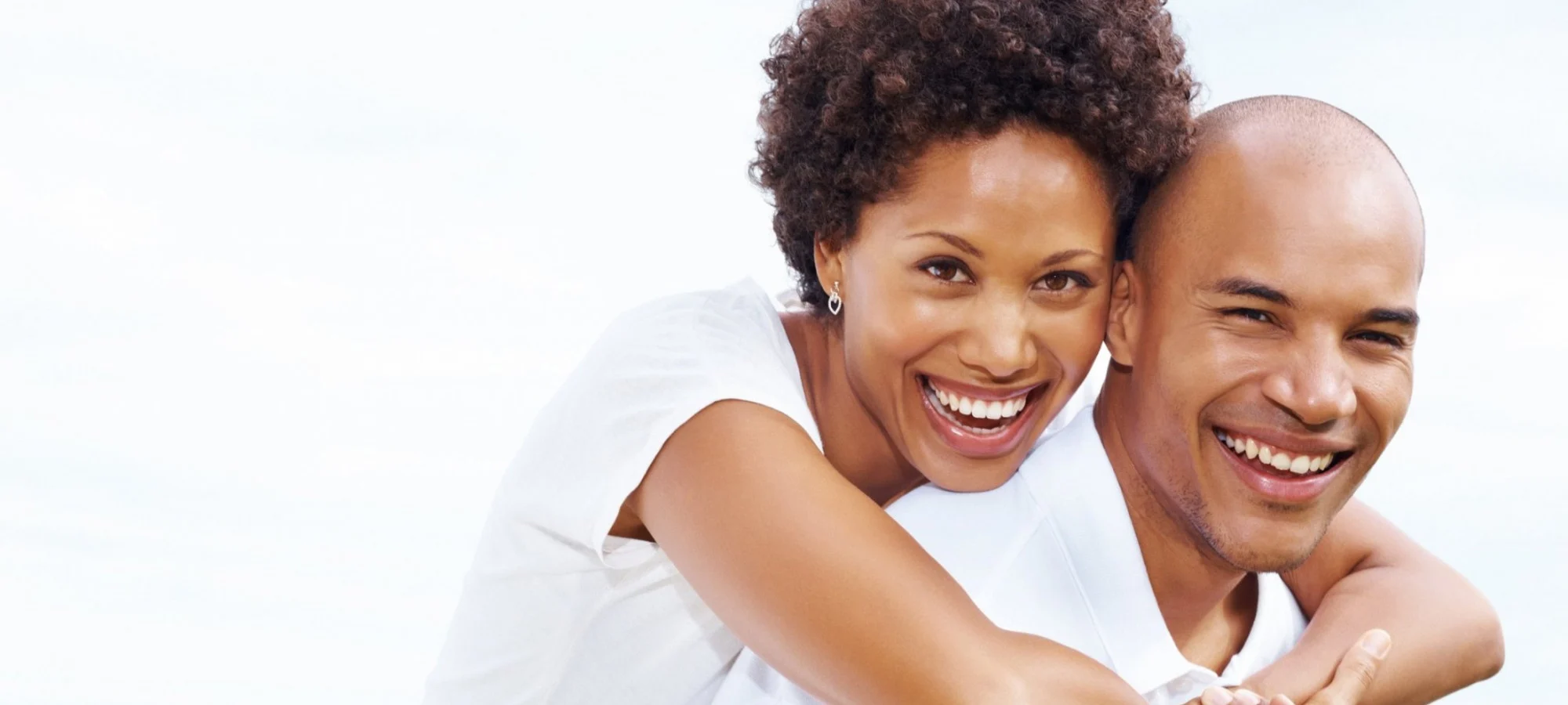 A couple sharing a bright, happy smile